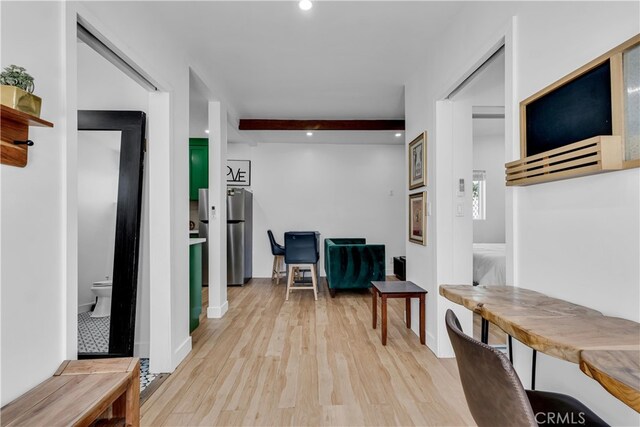 hall with wood finished floors, recessed lighting, and beam ceiling