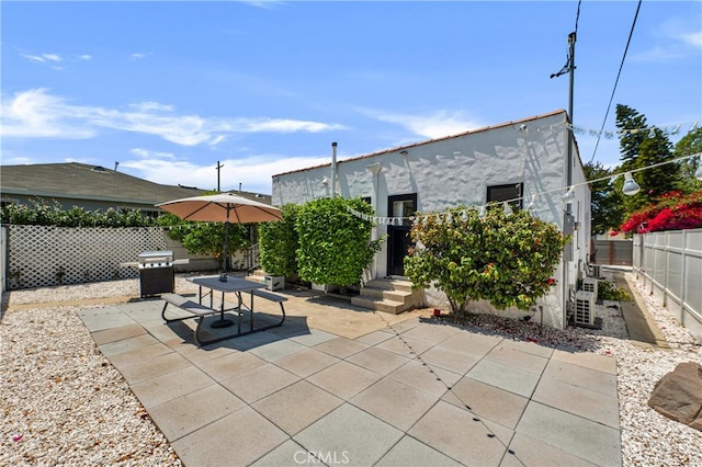 view of patio featuring a fenced backyard and a grill