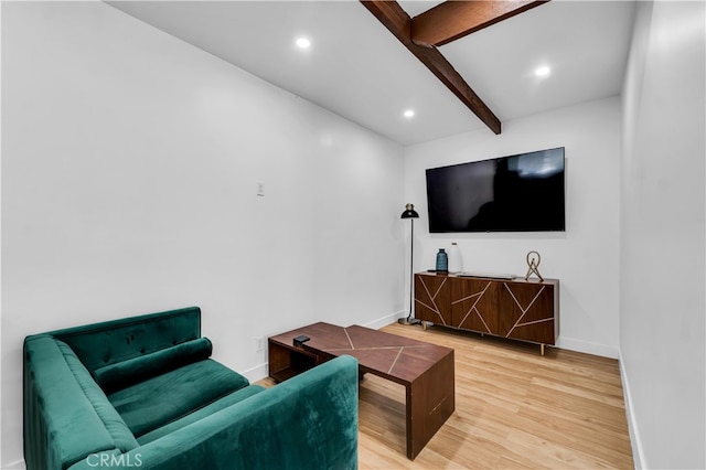 living area with light wood-style floors, beamed ceiling, baseboards, and recessed lighting