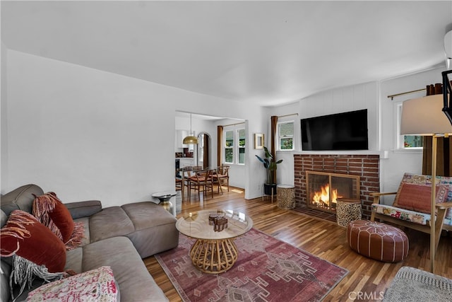 living room with wood finished floors and a fireplace