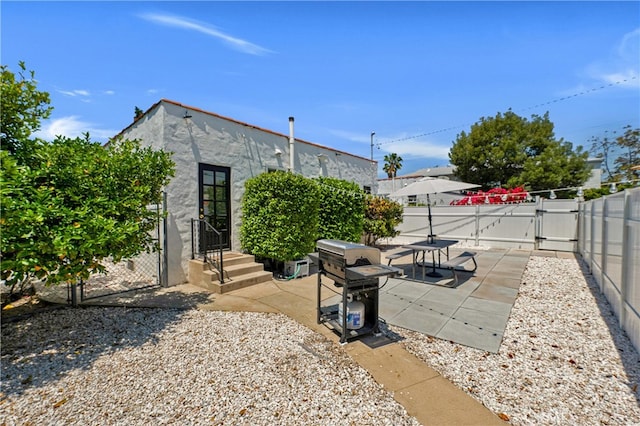 view of patio with a gate and a grill