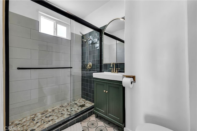 full bath with a shower stall, toilet, vanity, and tile patterned floors