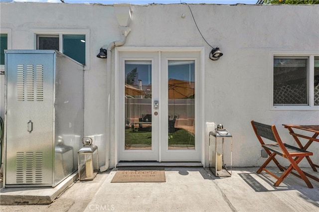 property entrance featuring french doors and stucco siding