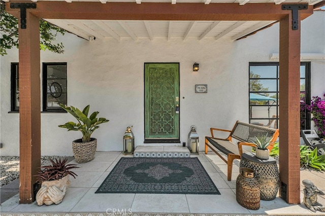 doorway to property featuring stucco siding