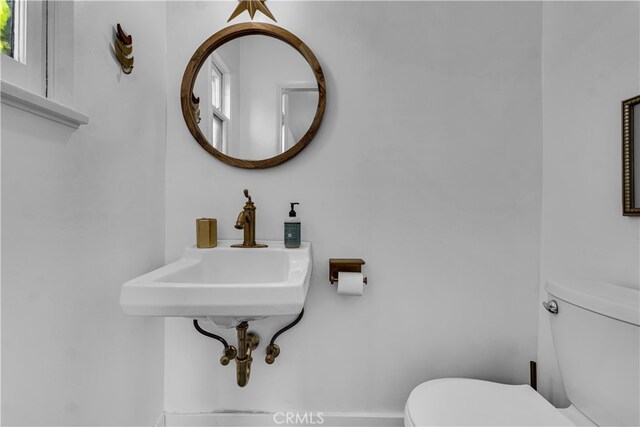 half bath with toilet and a sink