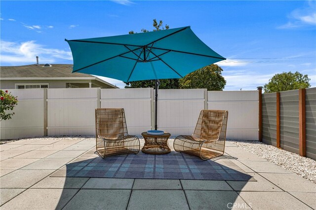 view of patio / terrace featuring fence