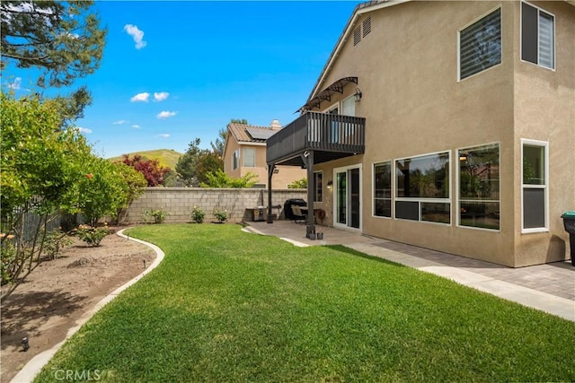 view of yard featuring a balcony and a patio area
