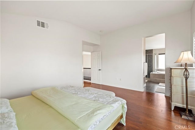 bedroom with wood finished floors and baseboards
