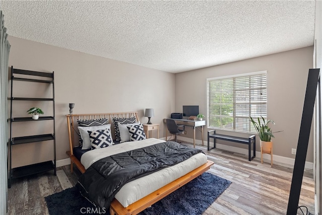 645 Pacific Ave Unit 304, Long Beach, CA 90802 - bedroom with wood finished floors, a textured ceiling, and baseboards