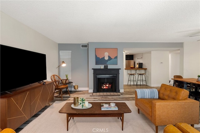 645 Pacific Ave Unit 304, Long Beach, CA 90802 - living room with a textured ceiling and a warm lit fireplace