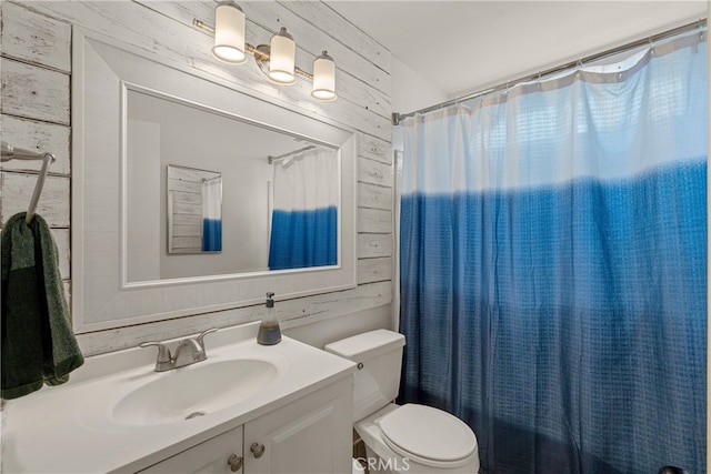 645 Pacific Ave Unit 304, Long Beach, CA 90802 - full bathroom with vanity, wooden walls, toilet, and a shower with shower curtain