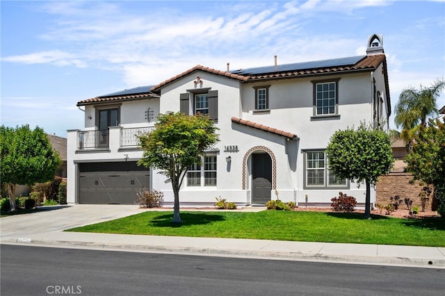 14538 Eagle River Rd, Eastvale, CA 92880 - mediterranean / spanish-style home featuring a balcony, a tiled roof, solar panels, a front lawn, and stucco siding