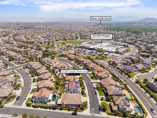 14538 Eagle River Rd, Eastvale, CA 92880 - aerial overview of property's location featuring a mountainous background and nearby suburban area