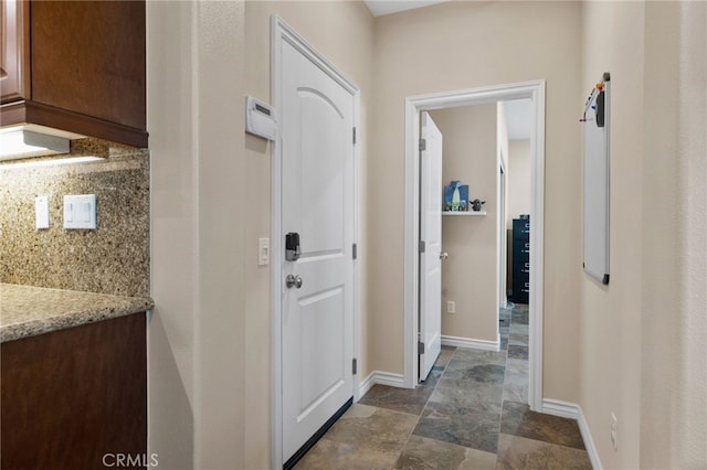 14538 Eagle River Rd, Eastvale, CA 92880 - entryway with baseboards and dark stone finish flooring