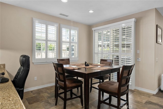 14538 Eagle River Rd, Eastvale, CA 92880 - dining room featuring baseboards, recessed lighting, and stone finish flooring