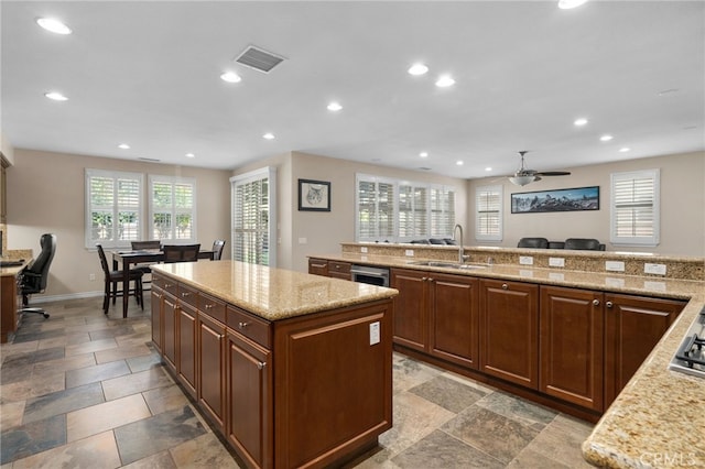 14538 Eagle River Rd, Eastvale, CA 92880 - kitchen featuring a sink, recessed lighting, a kitchen island, ceiling fan, and light stone counters