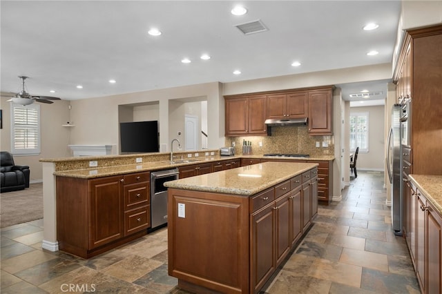 14538 Eagle River Rd, Eastvale, CA 92880 - kitchen featuring appliances with stainless steel finishes, open floor plan, under cabinet range hood, baseboards, and recessed lighting