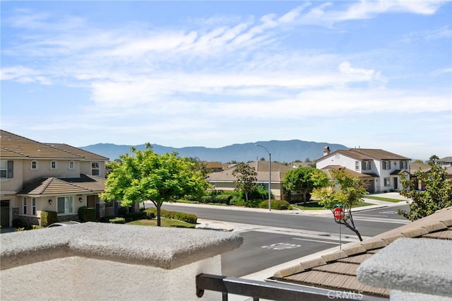 14538 Eagle River Rd, Eastvale, CA 92880 - view of asphalt road featuring a residential view, street lights, sidewalks, and a mountain view