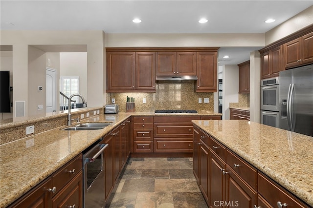 14538 Eagle River Rd, Eastvale, CA 92880 - kitchen with a sink, appliances with stainless steel finishes, under cabinet range hood, light stone countertops, and tasteful backsplash