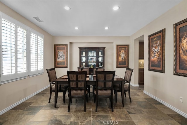 14538 Eagle River Rd, Eastvale, CA 92880 - dining space with dark stone finish flooring, baseboards, and recessed lighting
