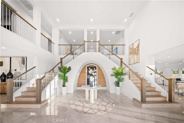 100 Headwaters, Irvine, CA 92602 - entryway featuring a towering ceiling, stairway, arched walkways, marble tiled floors, and recessed lighting