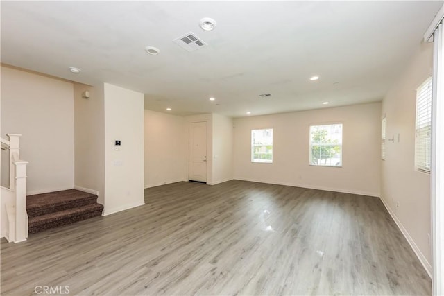 7460 Jersey St, Chino, CA 91708 - spare room with light wood-type flooring, stairway, recessed lighting, and baseboards