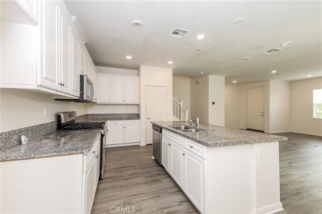 7460 Jersey St, Chino, CA 91708 - kitchen with appliances with stainless steel finishes, recessed lighting, light wood finished floors, a sink, and white cabinets