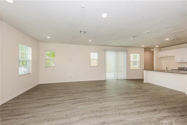 7460 Jersey St, Chino, CA 91708 - unfurnished living room with light wood finished floors, recessed lighting, and baseboards