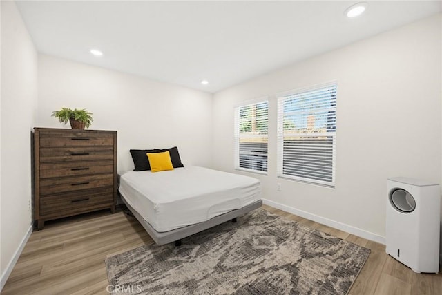 bedroom featuring light wood-type flooring, baseboards, and recessed lighting