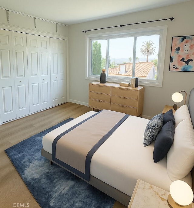 2844 E 3rd St Unit 210, Long Beach, CA 90814 - bedroom featuring wood finished floors, a closet, and baseboards