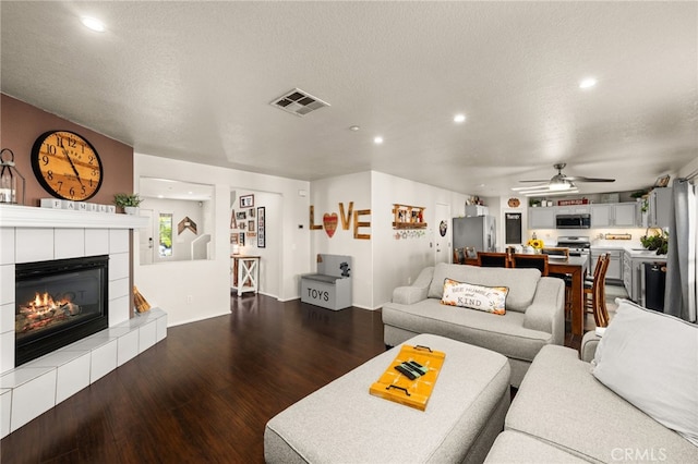 7189 Myrtle Pl, Fontana, CA 92336 - living room with a ceiling fan, dark wood finished floors, a tile fireplace, recessed lighting, and baseboards