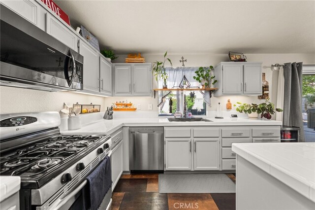 7189 Myrtle Pl, Fontana, CA 92336 - kitchen featuring appliances with stainless steel finishes, a sink, and tile counters