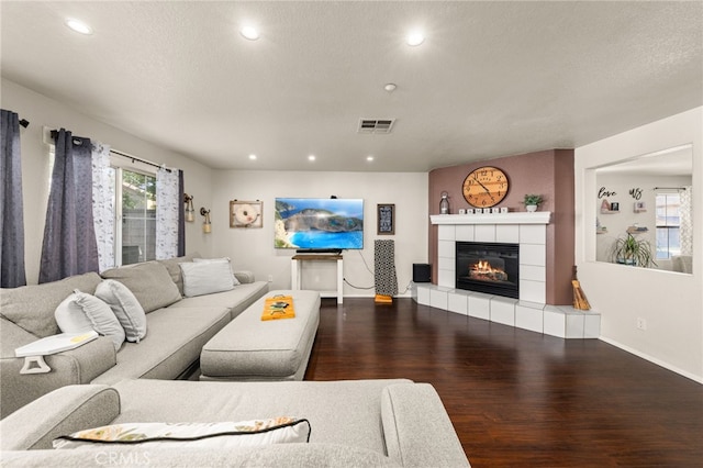7189 Myrtle Pl, Fontana, CA 92336 - living room featuring wood finished floors, recessed lighting, a tile fireplace, baseboards, and a textured ceiling