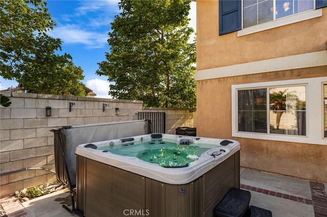 7189 Myrtle Pl, Fontana, CA 92336 - view of patio / terrace with a hot tub and fence