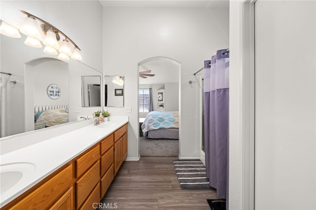 7189 Myrtle Pl, Fontana, CA 92336 - full bath featuring connected bathroom, double vanity, a ceiling fan, and wood finished floors