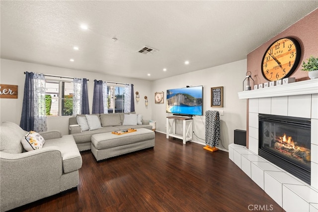 7189 Myrtle Pl, Fontana, CA 92336 - living room with wood finished floors, a tiled fireplace, recessed lighting, and a textured ceiling