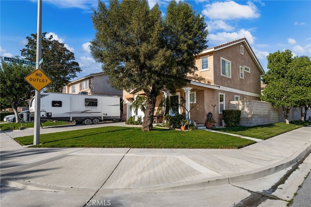 7189 Myrtle Pl, Fontana, CA 92336 - view of front facade with stucco siding, driveway, and a front lawn