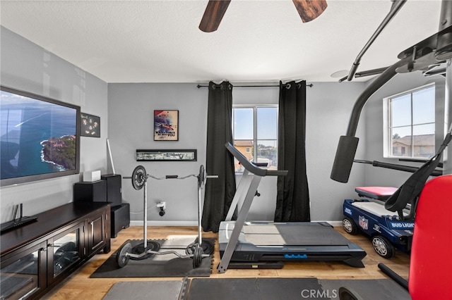 7189 Myrtle Pl, Fontana, CA 92336 - exercise area featuring light wood-type flooring, baseboards, and a textured ceiling