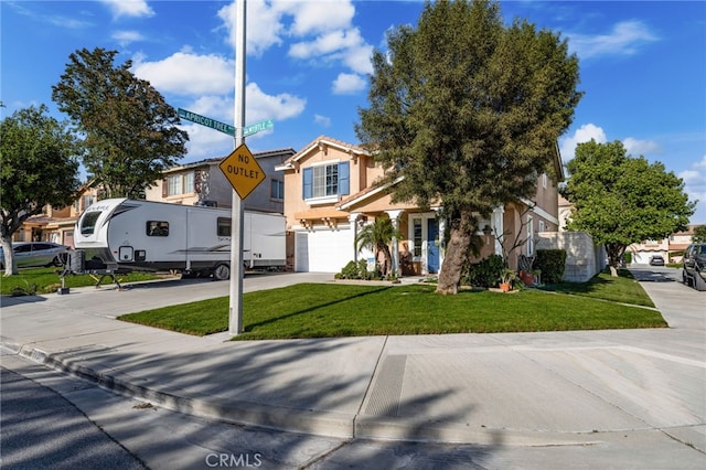 7189 Myrtle Pl, Fontana, CA 92336 - view of front of house featuring an attached garage, driveway, stucco siding, and a front lawn