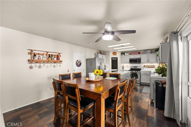 7189 Myrtle Pl, Fontana, CA 92336 - dining room with ceiling fan, dark wood-style flooring, and baseboards