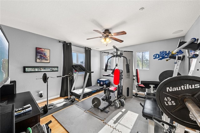 7189 Myrtle Pl, Fontana, CA 92336 - exercise area with ceiling fan, a textured ceiling, and baseboards