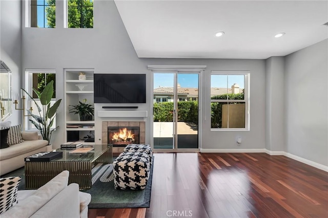 587 Fenwick Way Unit B, Simi Valley, CA 93065 - living area featuring wood finished floors, a tiled fireplace, baseboards, built in features, and recessed lighting