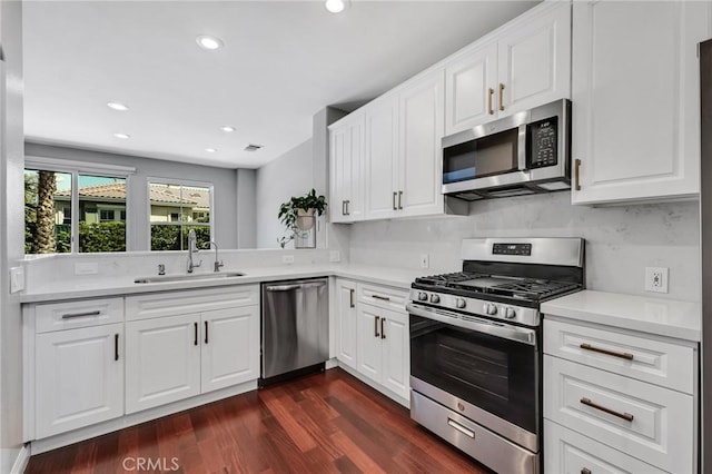 587 Fenwick Way Unit B, Simi Valley, CA 93065 - kitchen featuring appliances with stainless steel finishes, a sink, dark wood finished floors, white cabinets, and recessed lighting