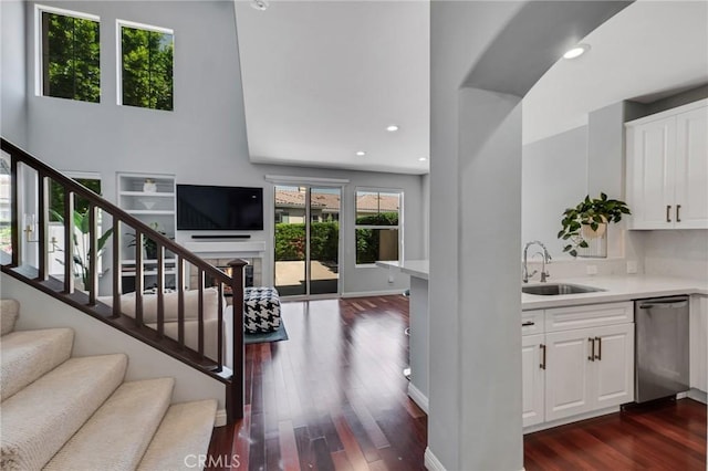 587 Fenwick Way Unit B, Simi Valley, CA 93065 - staircase with wood finished floors, recessed lighting, a towering ceiling, and a fireplace