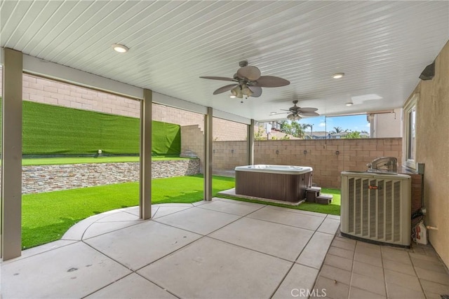 view of patio featuring a hot tub, central air condition unit, and ceiling fan