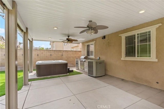 view of patio featuring a hot tub, a fenced backyard, a ceiling fan, and area for grilling
