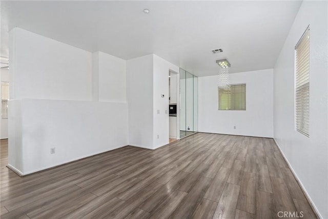 unfurnished living room with wood finished floors