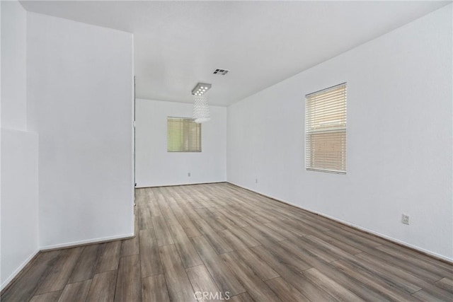 unfurnished room featuring wood finished floors and baseboards