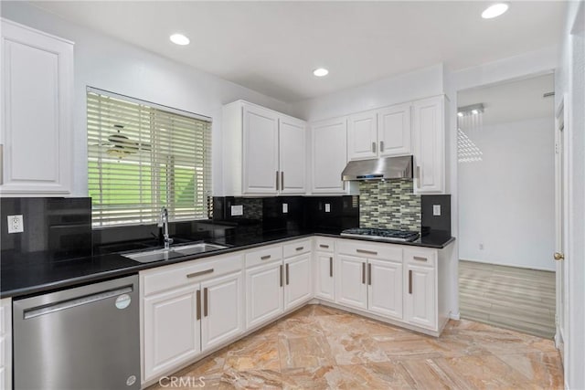 kitchen with appliances with stainless steel finishes, a sink, under cabinet range hood, dark countertops, and recessed lighting