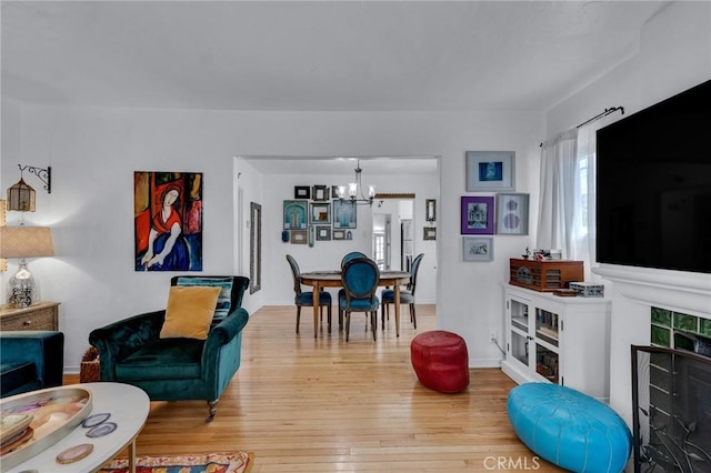 living room with a chandelier and light wood-style flooring